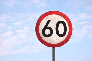 European dirty 60km speed limit traffic sign (blue sky background) clipart