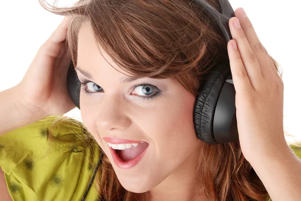 Beautiful teenage girl listening to music — Stock Photo, Image