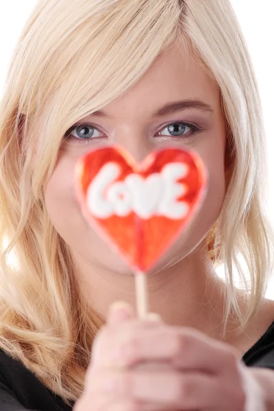 Teenage girl holding red lollipop — Stock Photo, Image