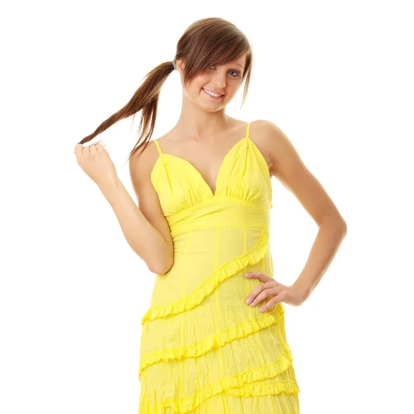 Beautiful brunette girl in yellow dress — Stock Photo, Image