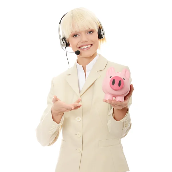 Kobieta z zestawu słuchawkowego piggy bank gospodarstwa — Zdjęcie stockowe