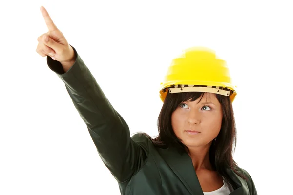 Young female architect or builder wearing a yellow hart hat — Stock Photo, Image
