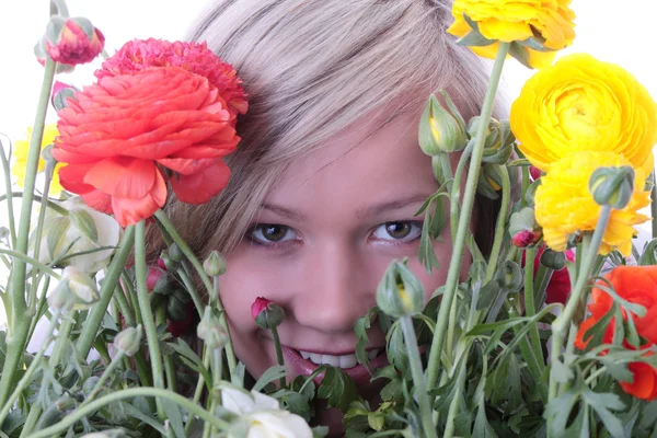 Blond woman hiding behind colorfoul flowers — Stock Photo, Image