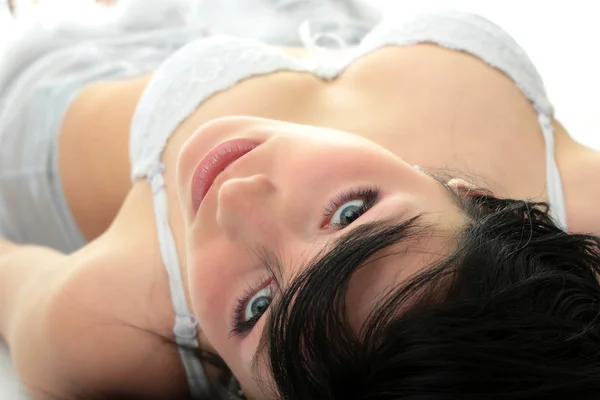 美しい幸せな女性ランジェリーでベッドの上のクローズ アップ — ストック写真