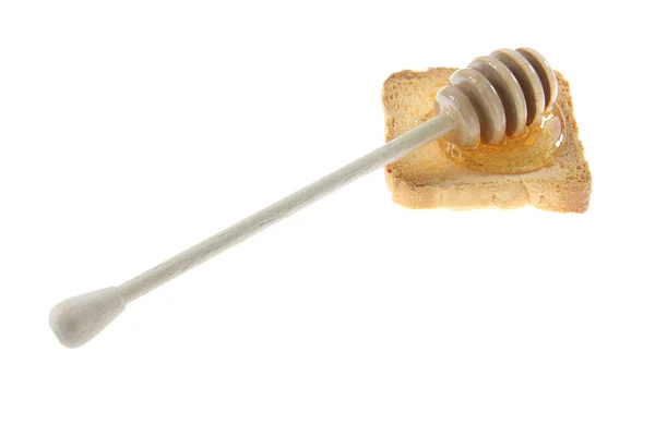 Дерев'яна медова мряка з медом на хлібі . — стокове фото