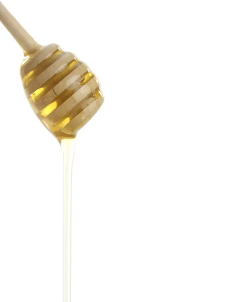 stock image Wooden honey drizzler with a honey isolated on white.