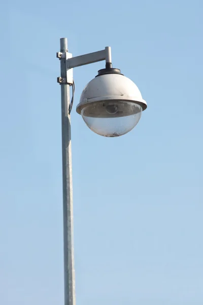 stock image Surveillance security camera against clear blue sky