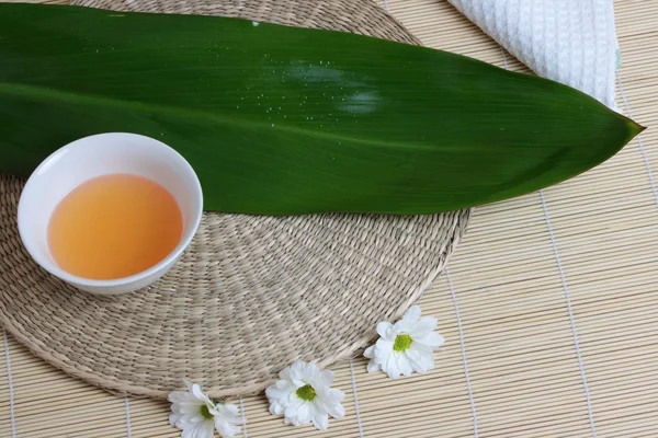 stock image Tropical Spa background (green leaf, white flowers, oil)