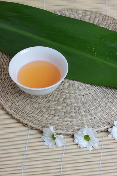 Stock image Tropical Spa background (green leaf, white flowers, oil)