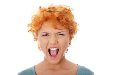 Furiouse young redhead woman screaming. clipart