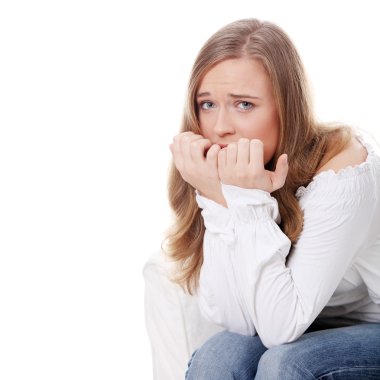 Stressed young woman eating her nails , isolated on white clipart