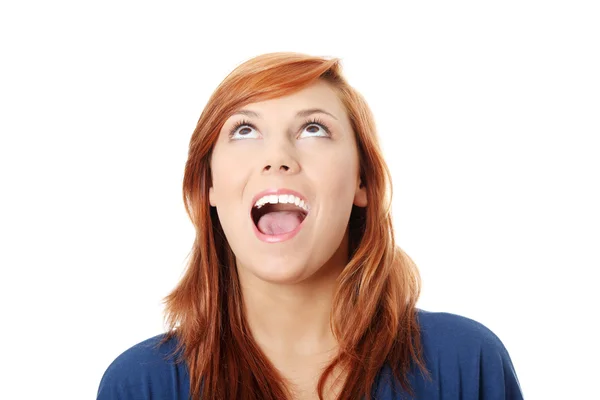 Surprised young woman looking up — Stock Photo, Image