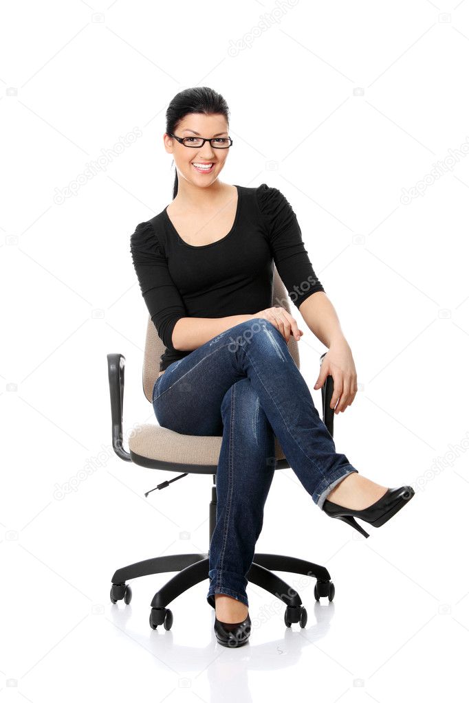 Young happy woman sitting on a wheel chair, isolated over a white background