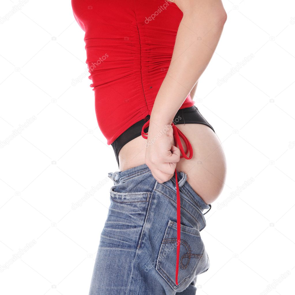 Woman trying to get in to old jeans.