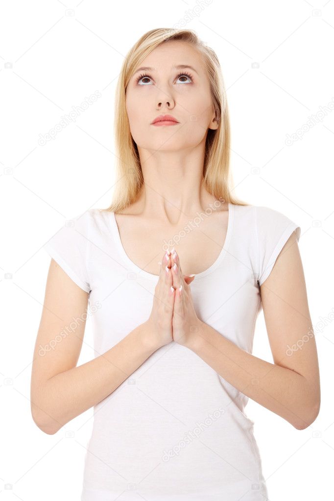 Young caucasian woman praying