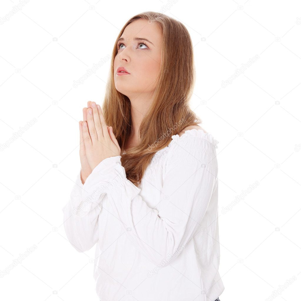 Closeup portrait of a young caucasian woman praying , isoalted on white