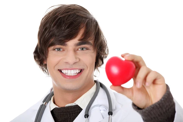 Happy Handsome Young Male Doctor Holding Heart Shape Toy Isolated — Stock Photo, Image