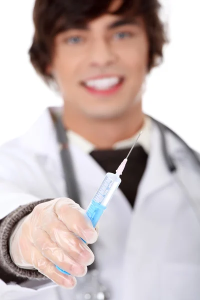Handsome young doctor holding syringe — Stock Photo, Image