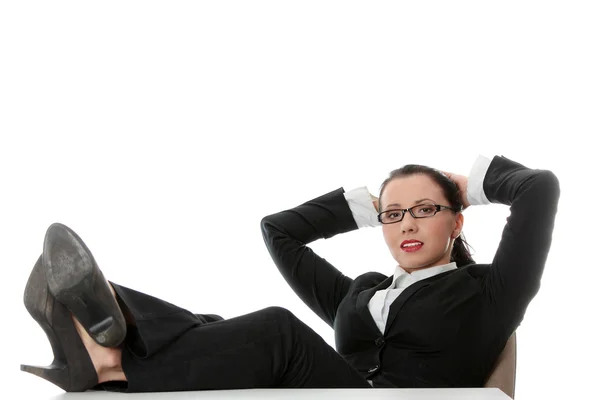 Giovane donna d'affari rilassante alla scrivania, gambe in su — Foto Stock