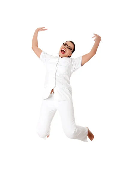 Smiling medical doctor or nurse jumping. — Stock Photo, Image