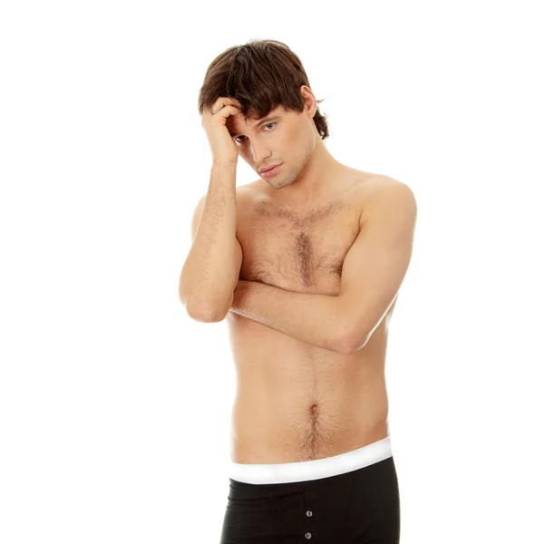 Nachdenklicher junger Mann in Unterwäsche. — Stockfoto