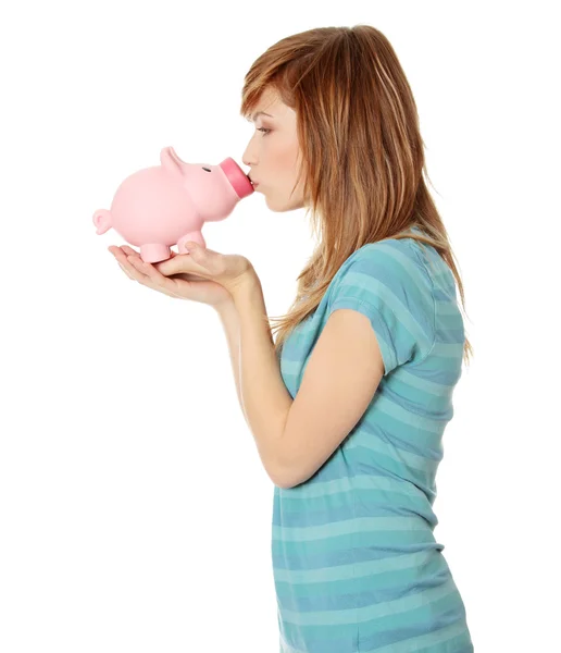 Kissing a piggy bank — Stock Photo, Image