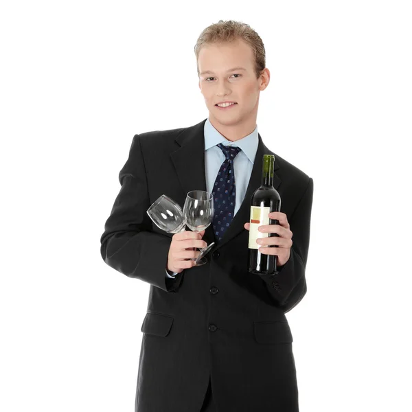 Jovem empresário bonito com garrafa de vinho — Fotografia de Stock