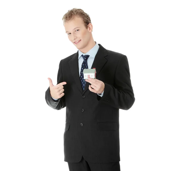 Young business man with house model — Stock Photo, Image