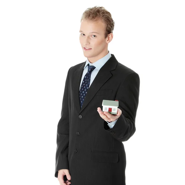 Young business man with house model — Stock Photo, Image