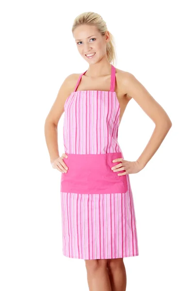 Gelukkig blonde naakte vrouw in roze schort — Stockfoto