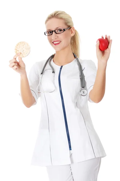 stock image Beautiful blond female doctor holding rice cake