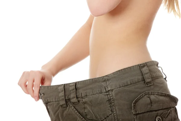 Female became skinny and wearing old pants — Stock Photo, Image