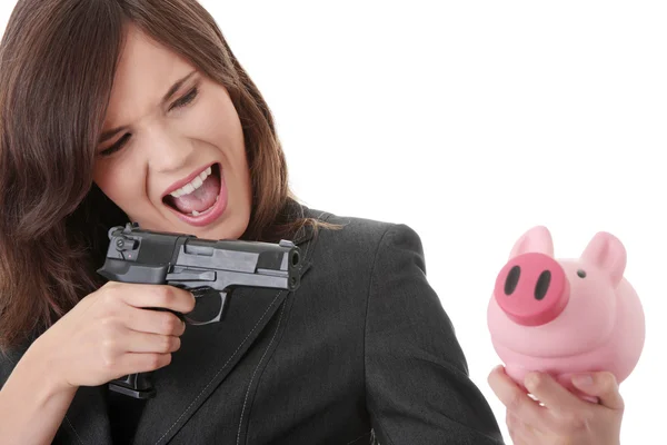 Kobieta z pistoletu, wskazując na piggy bank — Zdjęcie stockowe