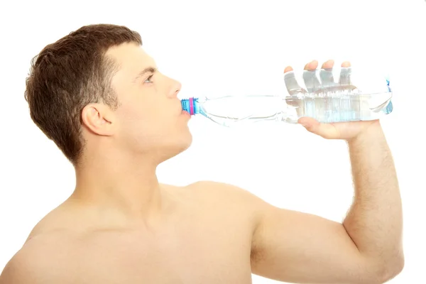 Attractive half naked man drinking water — Stock Photo, Image