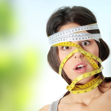 Woman with measuring tape around her head