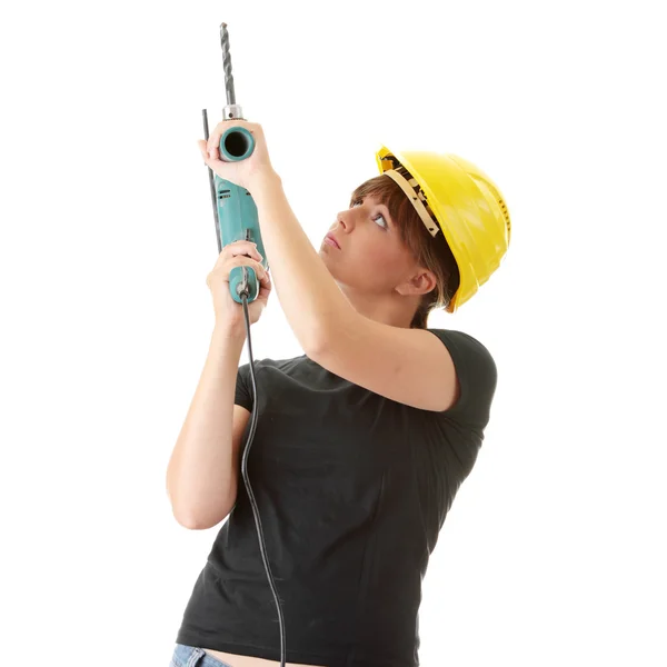 Молодая женщина строитель с бурильщиком — стоковое фото