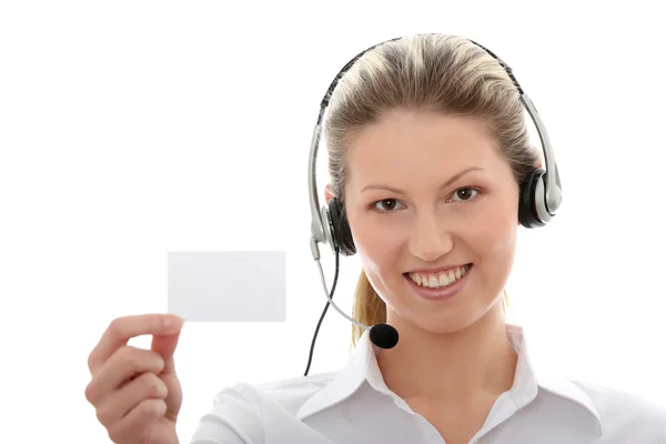 Mujer del centro de llamadas con auriculares que muestran tarjeta de visita — Foto de Stock