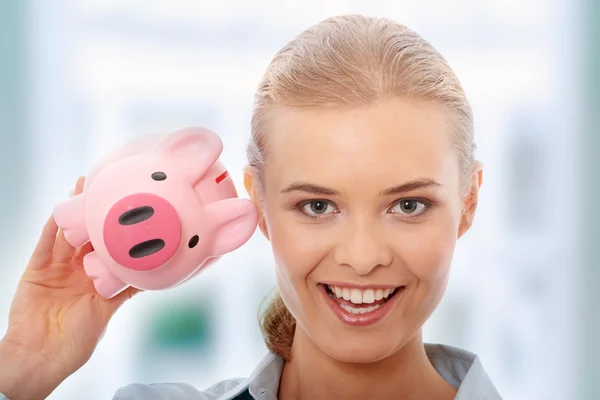 Businesswoman holding piggy bank — Stock Photo, Image