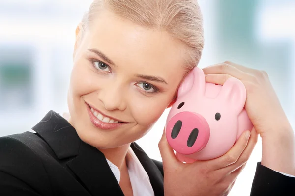 Businesswoman and piggy bank — Stock Photo, Image