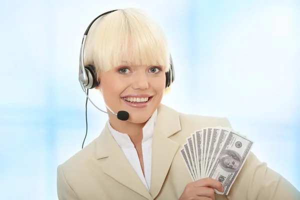 Obchodní žena s headsetem držet dolary — Stock fotografie