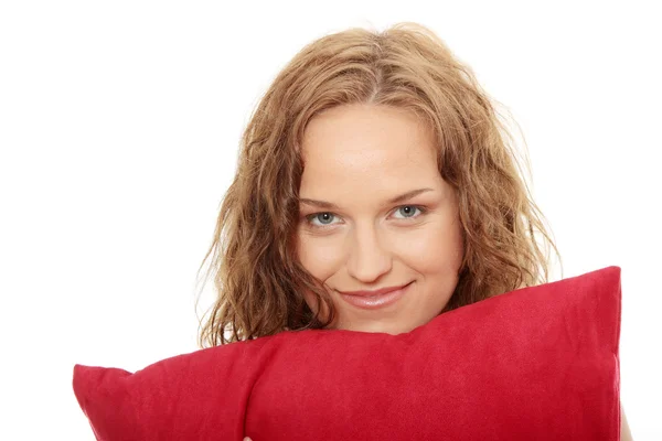 Beauty woman with red pillow — Stock Photo, Image