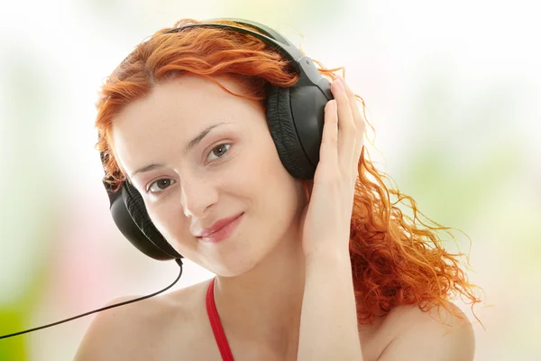 Redhead listening music — Stock Photo, Image