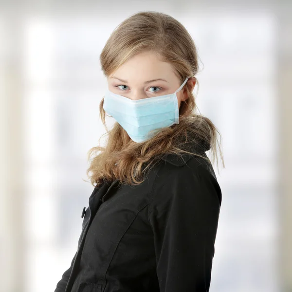 A model wearing a mask to prevent 'Swine Flu' infection. — Stock Photo, Image