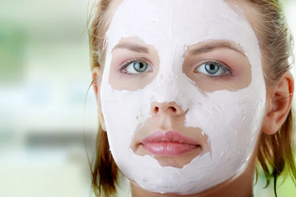 Young female face with clay mask — Stock Photo, Image