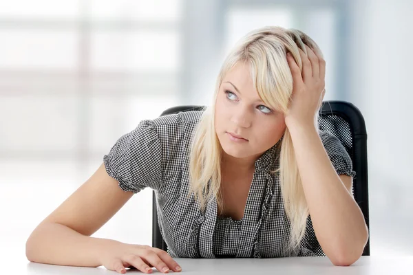 Closeup portrait of a young woman sitting with hands on desk and dreaming — Stock Photo, Image