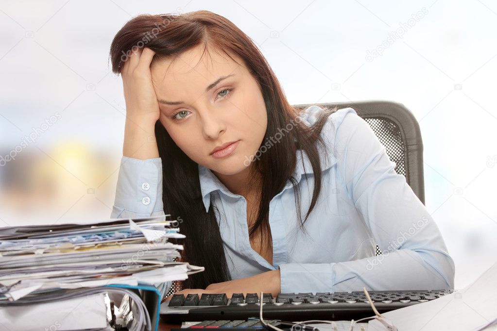 Exhausted female filling out tax forms
