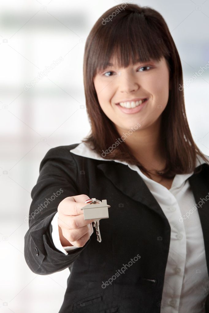 Beautiful woman holding keys and moneys