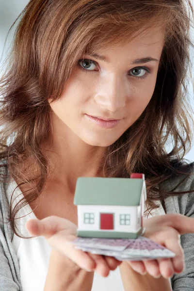 Young woman holding euros bills and house model — Stock Photo, Image