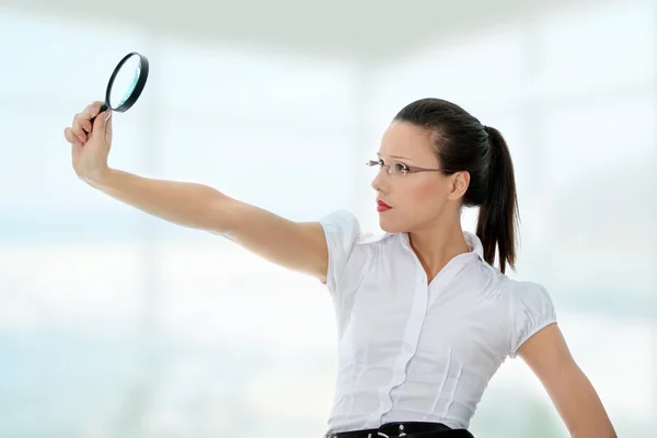 Business woman holding magnifying glass — Stock Photo, Image