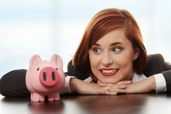 Businesswoman with her piggy bank. — Stock Photo, Image